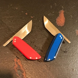 Pair of knives - one with red handle, one with blue handle